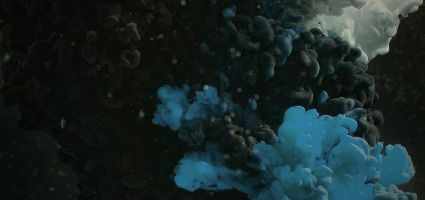 Abstract ink clouds diffusing in water