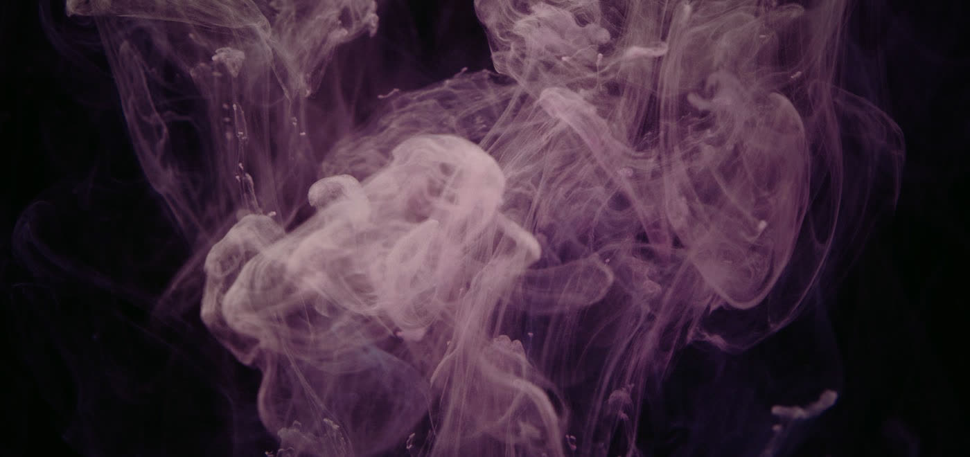 Abstract ink swirl against a dark background