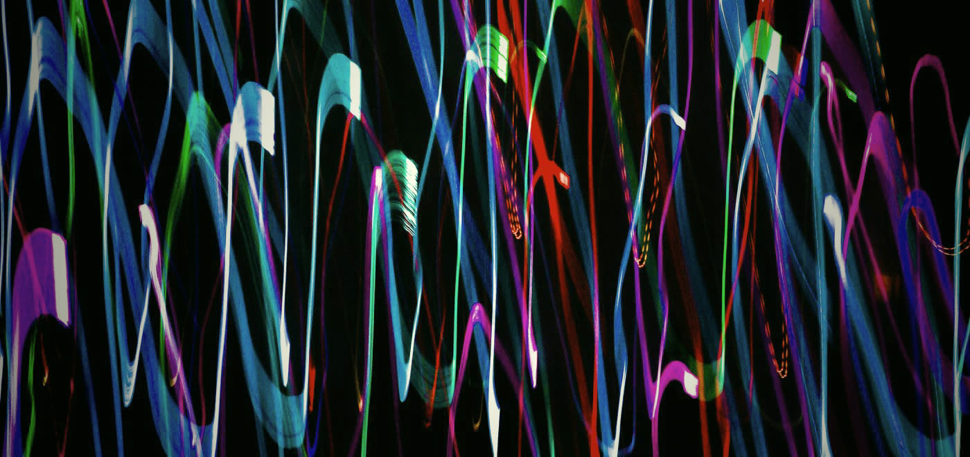 Abstract neon light trails on black
