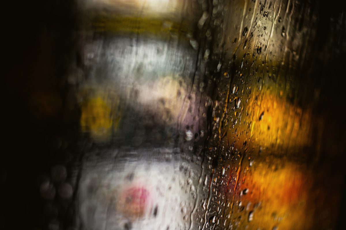 Defocused lights through rain on glass