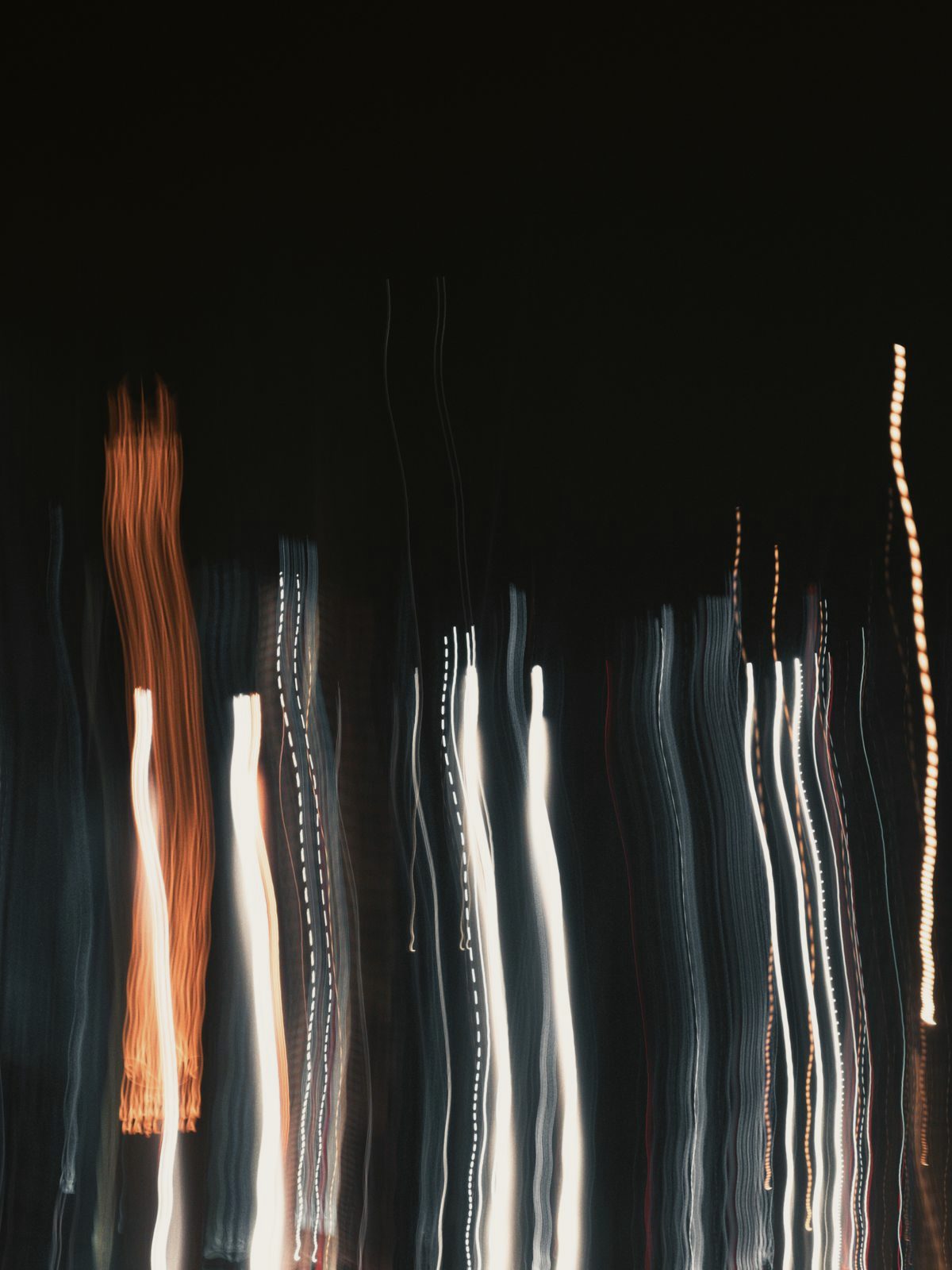 Abstract vertical light streaks in the dark